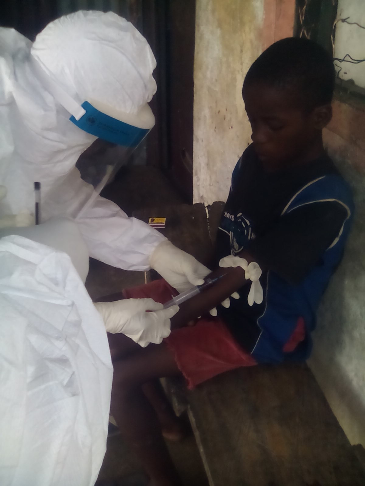 A 9-Yr old boy specimen is being taken at Nedowein Community by a Health worker